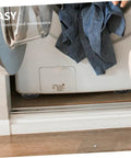 Four Pack Anti Skid Washing Machine Pads And Stabilizer Feet For Vibration Control visible under a washing machine on a hardwood floor