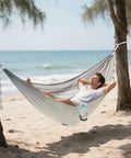 Person relaxing in Vintage Bathtub Camping Hammock, Ultra Lightweight And Portable, Heavy Duty 330 Lb Capacity With Soft 210T Parachute Nylon on beach