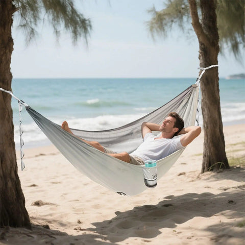 Person relaxing in Vintage Bathtub Camping Hammock, Ultra Lightweight And Portable, Heavy Duty 330 Lb Capacity With Soft 210T Parachute Nylon on beach