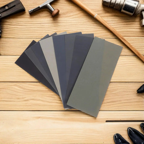 56pc Wet And Dry Sanding Kit with multi grit sheets 400 to 5000 grit carborundum paper on wooden surface