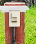 Rock Solid Outdoor EV Charger Cover Built Tough As Nails To Ward Off Rain And Grime With Smart Cross Ventilation on wooden post.