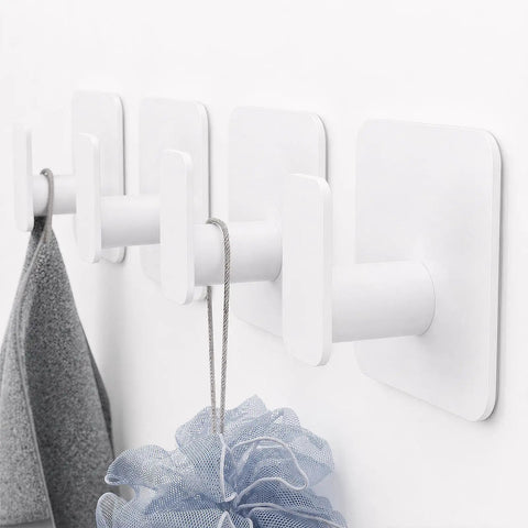 Heavy Duty Adhesive Wall Hooks That Hold Like A Champ, Zero Hassle No Sweat Mounting For Showers And Kitchens, Waterproof Rustproof Sticky Wall Hangers With A Grippy Fit, Kickin Performance Set Of Six White holding a gray cloth and blue loofah.