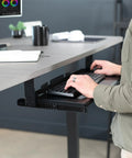 Large Height Adjustable Under Desk Keyboard Tray With Straight Up Smooth Glide Slide Out Platform Zero Hassle Ergonomic Typing Setup Rich Matte Black Computer Drawer in use with keyboard.