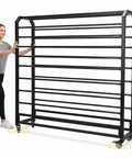 Heavy Duty Commercial Fabric Roll Storage Rack With Adjustable Spacing Rock Solid For Indoor And Outdoor Use No Sweat Textile Organization Top Shelf Steel Unit being pushed by a person.