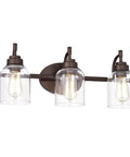 Adair 3 Light Bath Vanity Light in Oil Rubbed Bronze with Clear Glass Bell Shades 24 Inch Wide Transitional Indoor Fixture for Up Light and Down Light Perfect for Any Bath Update, front view.