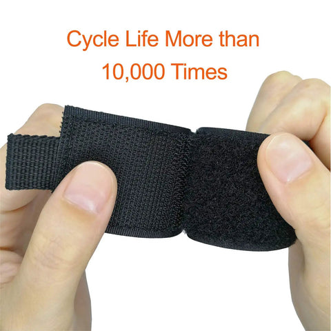 Hands holding black heavy duty storage strap showing velcro detail, part of Extension Cord Holder Organizer 4 Pack Large 16 Inch Heavy Duty Storage Straps For Garage Organization And Home Storage Cord Hanger With Triangle Buckle Dope Garage Gadgets For Men.