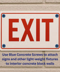 One Quarter Inch Hex Head Concrete Screw Anchor With Drill Bit For Masonry Brick Or Block Self Tapping Diamond Point Quick Install ANSI Compliant Bit Included 100 Count Box Pro Grade Quality used to attach a red 'EXIT' sign to a concrete block wall.