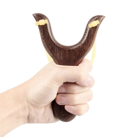 Solid Wood Slingshot With Classic Construction For Adults Heavy Duty Outdoor Catapult Style Toy held by hand, deep brown finish