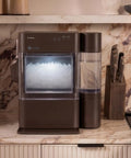 Countertop Nugget Ice Maker With 38 Lbs Daily Capacity And One Gallon Tank on a marble countertop, featuring chewable pebble ice.