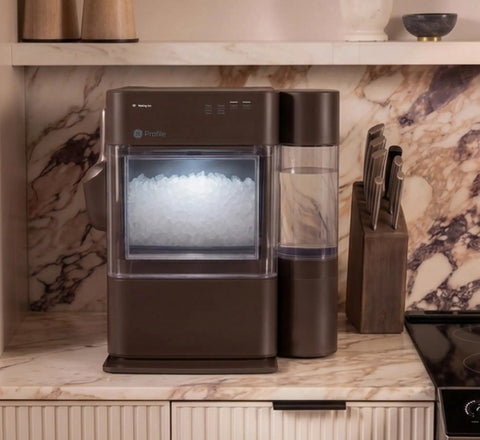 Countertop Nugget Ice Maker With 38 Lbs Daily Capacity And One Gallon Tank on a marble countertop, featuring chewable pebble ice.
