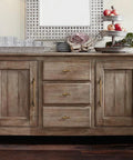 Front view of rustic sideboard with Six Pack 3 Inch Hole Center Cabinet Pulls Antique Brass Zinc Alloy Drawer Handles, decorated with glassware.