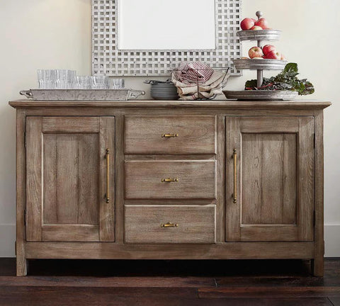 Front view of rustic sideboard with Six Pack 3 Inch Hole Center Cabinet Pulls Antique Brass Zinc Alloy Drawer Handles, decorated with glassware.