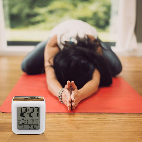 Farm Tractor Alarm Clock With LED Display, Seven Color Night Light, Sleep Training, and OK to Wake Feature placed on yoga mat