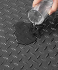 Water being poured on a Heavy Duty Rubber Flooring Roll 4 By 15 Foot Diamond Plate Mat, 3mm Thick, Wear Resistant SBR, Non Slip Floor Protector.