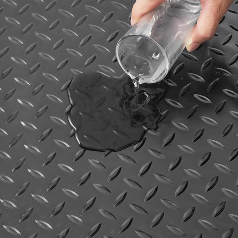 Water being poured on a Heavy Duty Rubber Flooring Roll 4 By 15 Foot Diamond Plate Mat, 3mm Thick, Wear Resistant SBR, Non Slip Floor Protector.