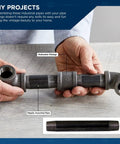 Hands holding assembled three eighths inch black steel pipe ten inch nipple set for DIY furniture and black pipe shelving.