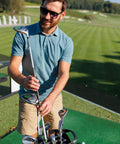 Man on golf course with club; not related to Two Pack Golf Club Shaft Extension Rods For Wood Putters, Carbon Fiber Putter Extenders