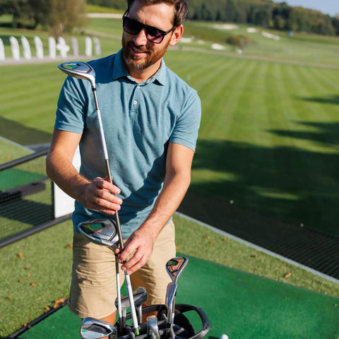 Man on golf course with club; not related to Two Pack Golf Club Shaft Extension Rods For Wood Putters, Carbon Fiber Putter Extenders