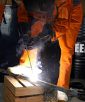 Split Leather Welding Pants With Heat And Flame Resistant Safety Leg Protection For Men And Women, Adjustable From M To XXXL, Regular 34 Inch, Durable Brown Workwear in action during welding.