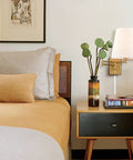 Gold Swing Arm Wall Sconces Two Pack Plug In Brass Wall Lights With White Fabric Shade in bedroom with nightstand