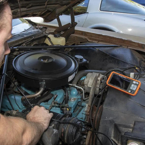 Mechanic using WiFi Pro Borescope With Dual Lens 5.5 mm 9.8 Foot Armored Waterproof Gooseneck Endoscope to inspect car engine