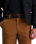 Man wearing brown pants with No Metal Visible Mechanic Belt For Men Black Large No Scratch Belt With Hidden Buckle Keeps Your Pants Up Without A Flashy Belt Durable Work Waistband For Builders And Techs, visible under black jacket.
