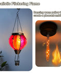 Two Pack Hot Air Balloon Solar Lanterns with Metal Shepherds Hook for Outdoor Pathway Lighting, cozy flickering flame close-up