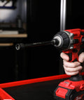 Close-up of a cordless drill with Magnetic Impact Nut Driver Set, 7/16 Inch, 6 Inch Long attached, ideal for tight spots.