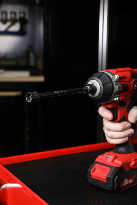 Close-up of a cordless drill with Magnetic Impact Nut Driver Set, 7/16 Inch, 6 Inch Long attached, ideal for tight spots.