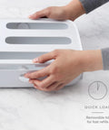 Hands opening StoraBag Drawer Food Bags Dispenser For Kitchen Storage 4 Slot Plastic Sandwich Bag Organizer with removable lid.