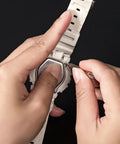 Using micro screwdriver from All In One Eyeglasses Repair Kit With 1100 Tiny Screws to adjust a watch, showcasing repair versatility.