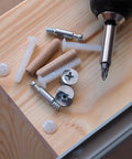 Straight Up Solid 40 Pack Screw Cap Covers Premium Warm White Decorative Plastic Caps For Phillips Cam Lock Nuts Waterproof PP Build Self Tapping Screws No Sweat Upgrade Top Tier with various screws on wood surface.