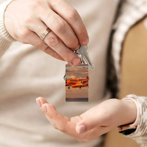 Hands holding Orange Daylight Aircraft Keychain Set with Personalized Acrylic Keyrings, Chains and Jump Rings.