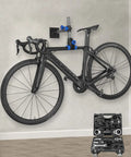 Wall Mounted Bike Repair Stand With Height Adjustable Clamp And Workbench Mount For Road And Mountain Bikes DIY Friendly Home Bicycle Maintenance Rack For Quick Repairs supporting a black bike on a wall.