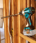 18V LXT Brushless Cordless Hammer Drill And Impact Driver 2 Piece Combo Kit With 5.0Ah Batteries shown in wooden framing