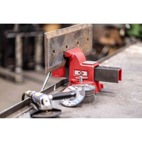Swivel Bench Vise Six Inch Opening With Three And A Half Inch Throat, 360 Degree Rotating Base With Lock Down in use on workbench