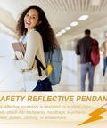 Student with backpack wearing Thunder Shaped Safety Reflector Pendant Keychain Set With Chain, walking in corridor.