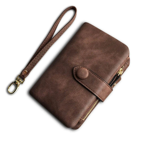 Must Have Women's Small Bifold Leather Wallet With RFID Blocking And Wristlet Strap, shown in brown, with snap closure and zipper.