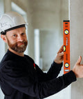 Heavy Duty Boss Level 18 Inch Torpedo Level With Reinforced Aluminum Body And Bright Green Bubble Vials held by a smiling man in a hard hat.