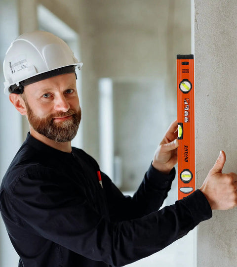 Heavy Duty Boss Level 18 Inch Torpedo Level With Reinforced Aluminum Body And Bright Green Bubble Vials held by a smiling man in a hard hat.