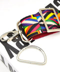 Close-up of 15 Piece Top Shelf Metal Swivel Snap Hooks And D Rings With Tri Glide Slide Buckles For Lanyard Purse Bag Straps And Dog Collars Straight Up Diy Sewing Hardware Kit In Smooth Silver with colorful strap.