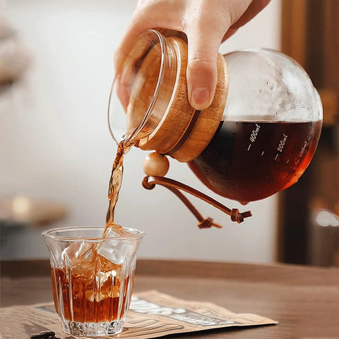 Top Shelf Cold Brew Drip Tower and Ice Drip Coffee Machine pouring cold brew from 400ml glass carafe into a glass.