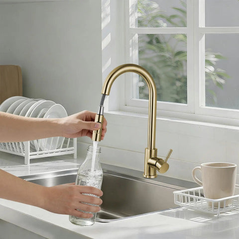 Sink Faucet,360°Pull-Out Spray,Brushed Steel Hot and Cold Rotation (Gold) in kitchen filling bottle with water.