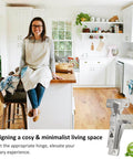 Woman sitting in a minimalist kitchen with a Face Frame Inset Cabinet Hinge Set 2 Pack Soft Close Silent 6 Way Adjustable 105 Degree displayed.