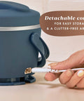 Hand detaching cord from Portable 20-Ounce Electric Food Warmer Personal Lunch Box Keeps Food Spill-Free And Warm Ideal For Travel Work School
