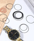 Watch Gasket O Ring Kit 80 Pcs Waterproof Rubber Seal Washers for Back Cover Replacement in 0.5 0.6 0.7 0.8 mm Sizes on display with watch.