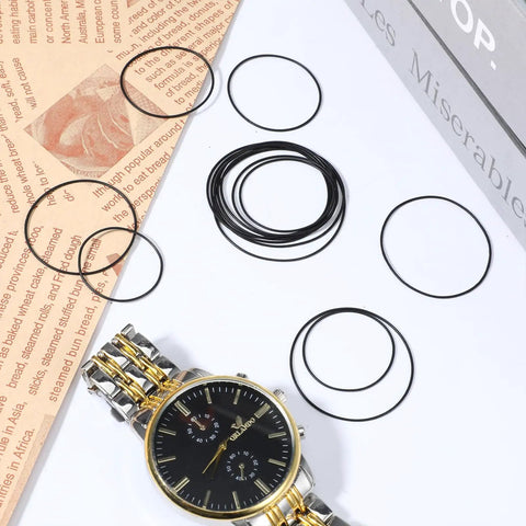 Watch Gasket O Ring Kit 80 Pcs Waterproof Rubber Seal Washers for Back Cover Replacement in 0.5 0.6 0.7 0.8 mm Sizes on display with watch.