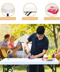 Man using Portable Outdoor Fish Cleaning Table With Sink And Sprayer at picnic outdoors, showing smooth HDPE surface and 360° faucet.