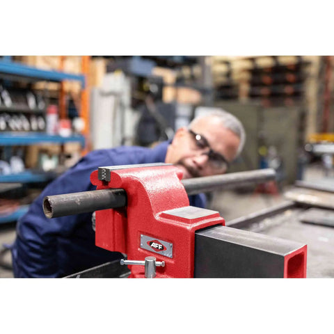 Swivel Bench Vise Six Inch Opening With Three And A Half Inch Throat, 360 Degree Rotating Base With Lock Down in use in workshop