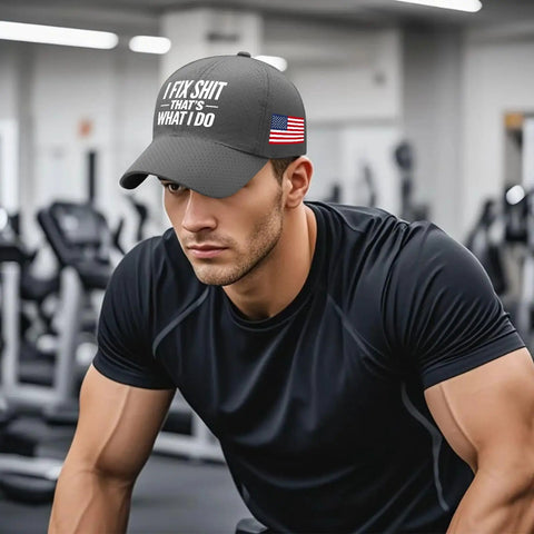 Man wearing a cap with "I Fix Shit That's What I Do" text and American flag emblem in a gym setting.
